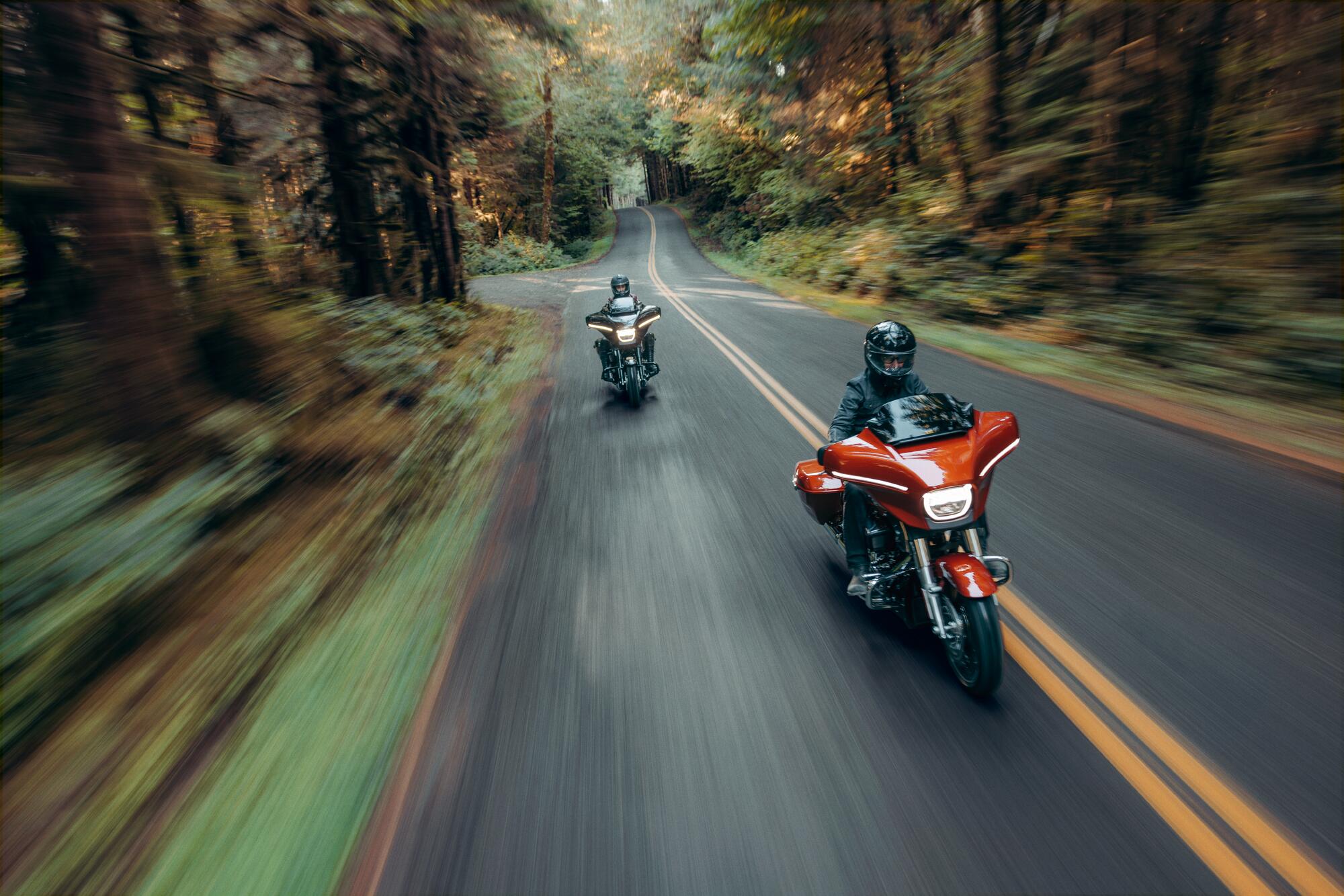 Bikes riding down a road