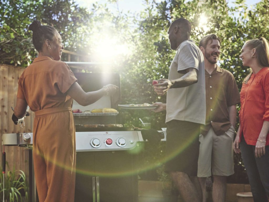 People standing by a barbecue