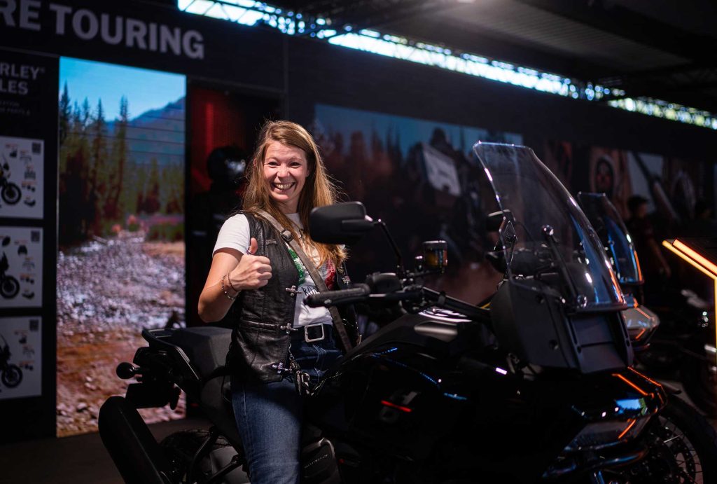 Visitors trying out motorcycles at the show