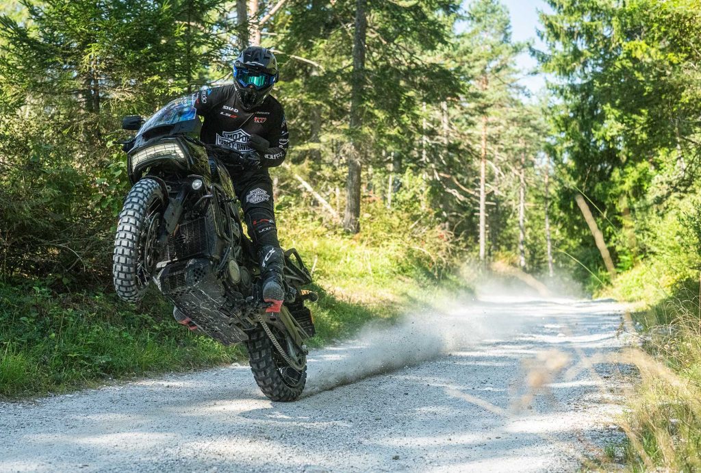 H-D Pan America being ridden cross country with rider pulling a wheelie