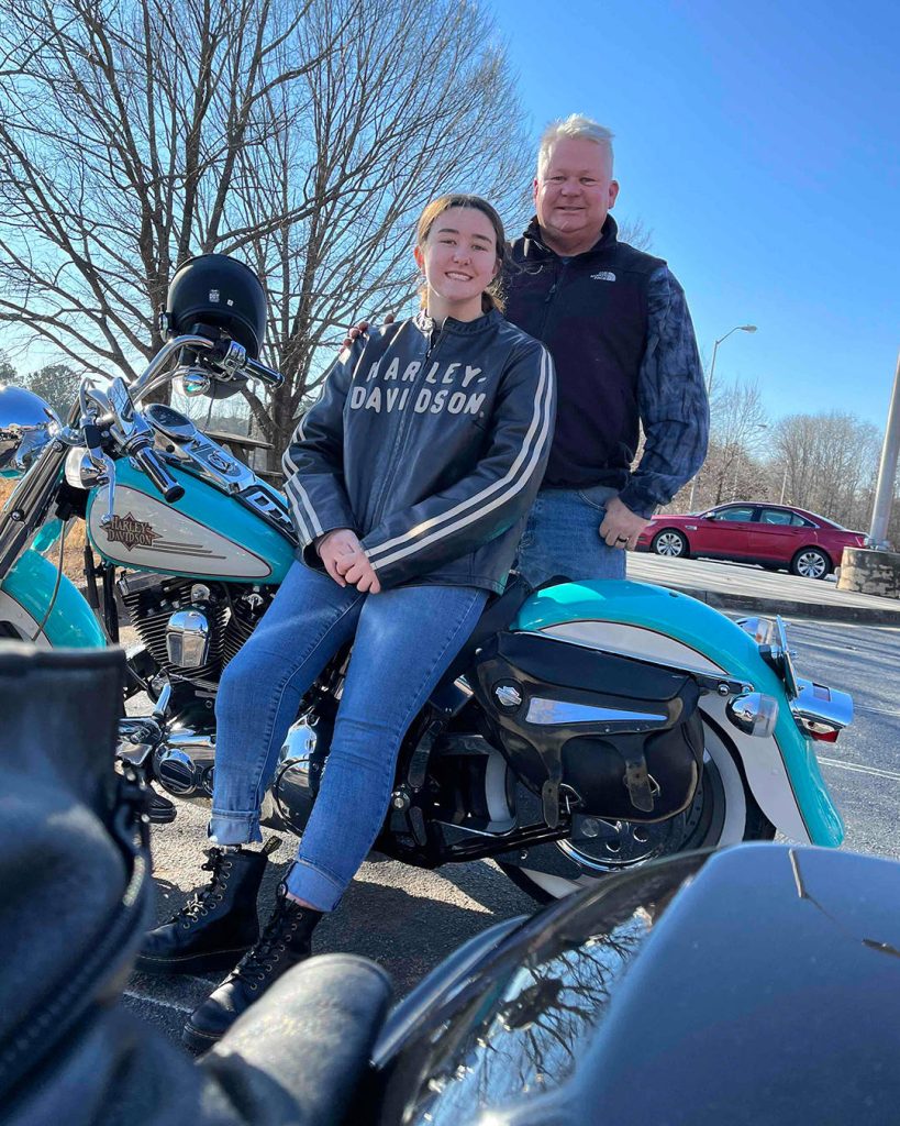 Isabel Marble with her father and motorcycle