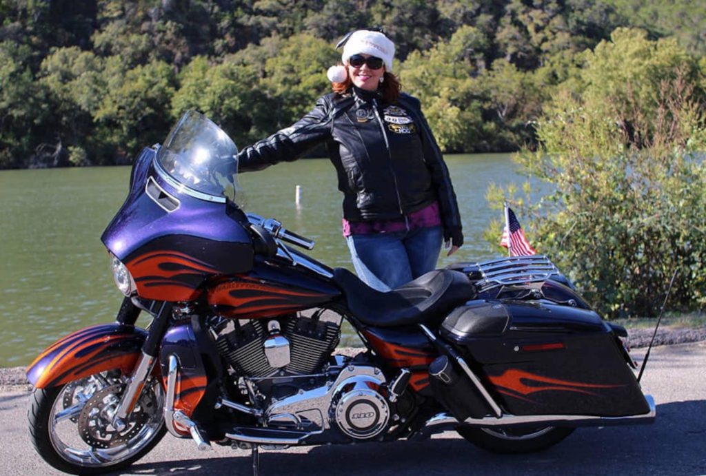 Casey beside her H-D motorcycle